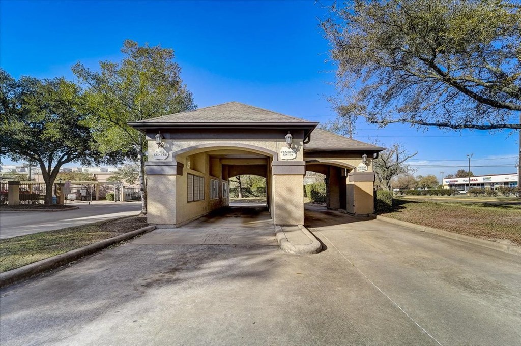the entrance to a park with a covered pavilion