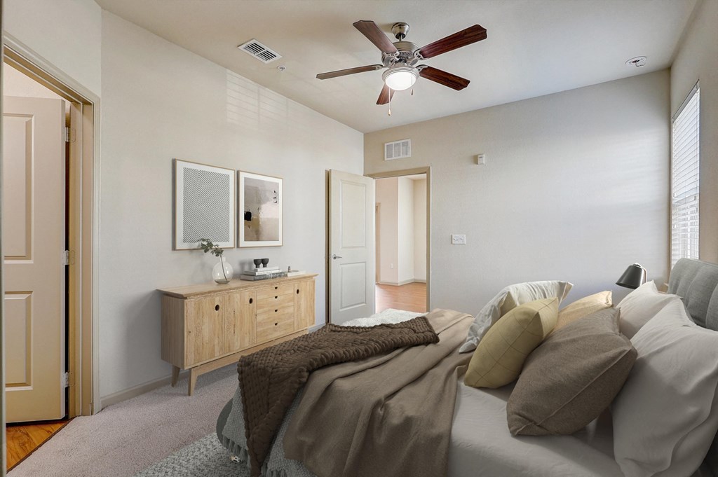 a bedroom with a large bed and a ceiling fan