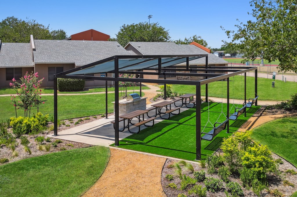 a pergola with a picnic table under it