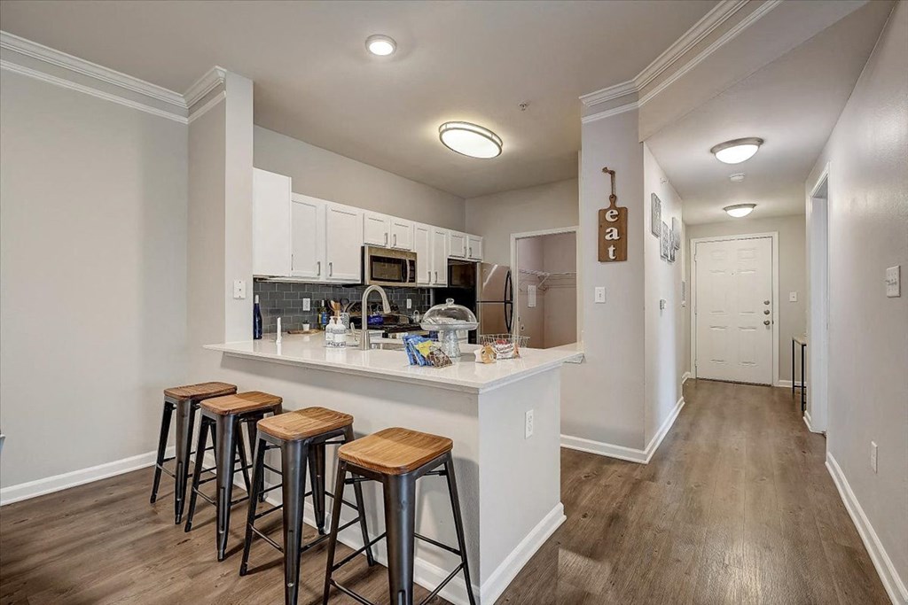 a kitchen with a breakfast bar and stools