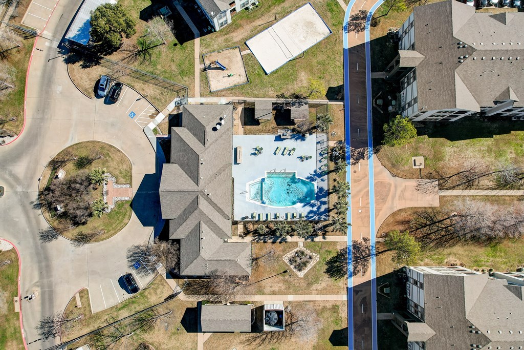 an aerial view of a house with a pool on its roof