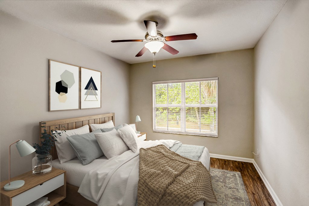 an empty bedroom with a ceiling fan and a bed