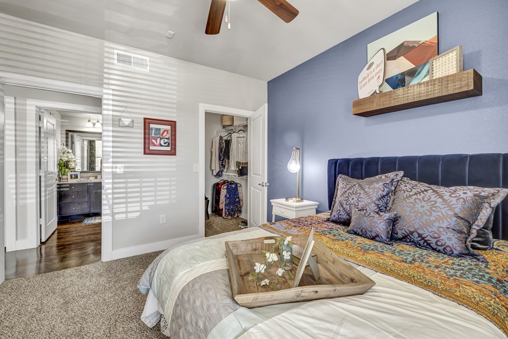 a bedroom with blue walls and a bed with a tray