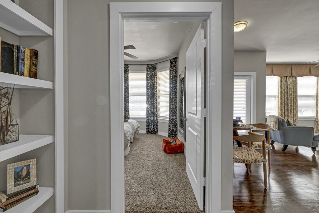 a view of a living room and a bedroom from a hallway