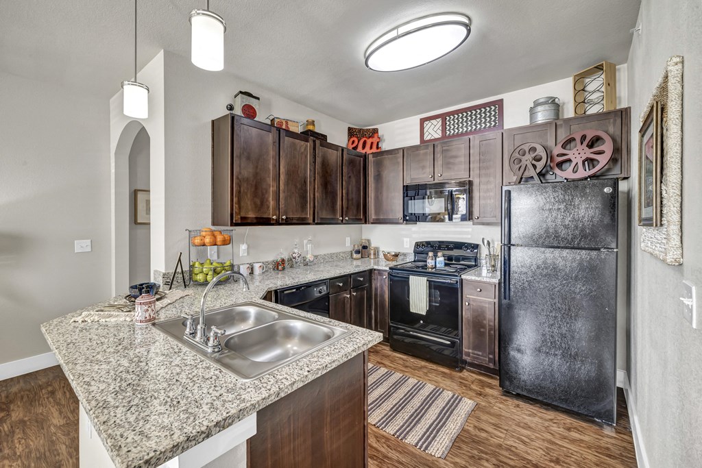 a kitchen with stainless steel appliances and granite counter tops