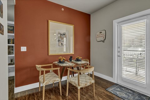 a dining room with a table and chairs and a window
