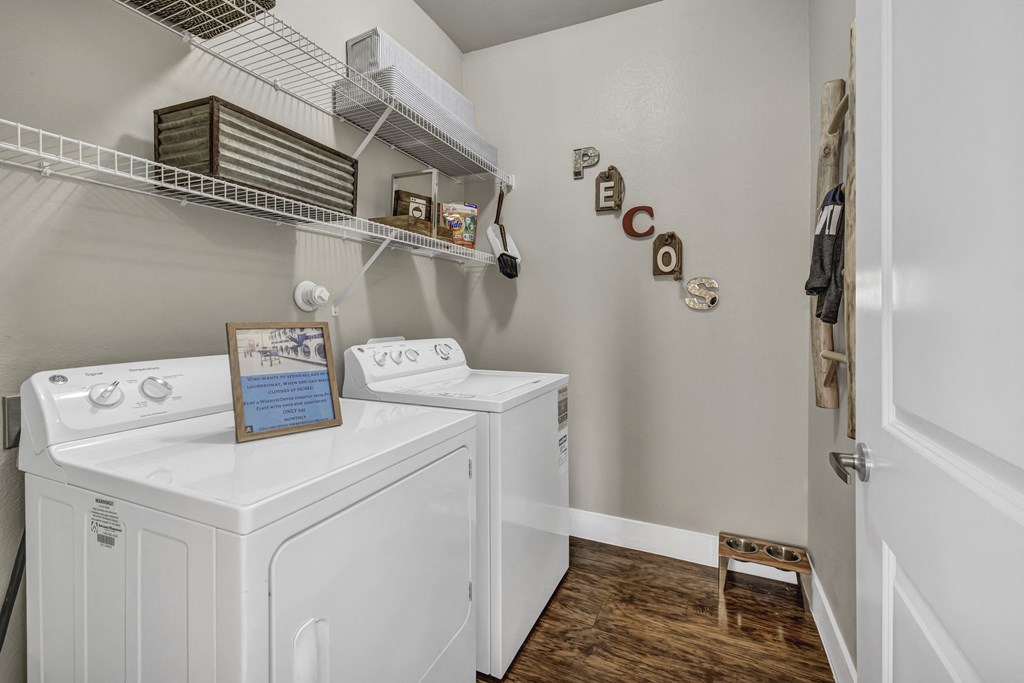 a washer and dryer in a laundry room with a door to a closet