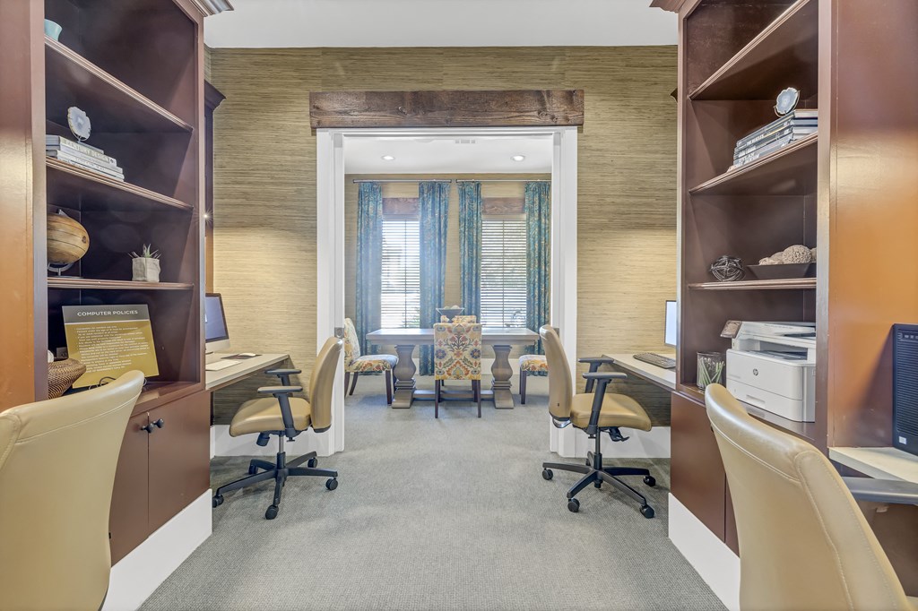 a large office with desks and chairs and a window