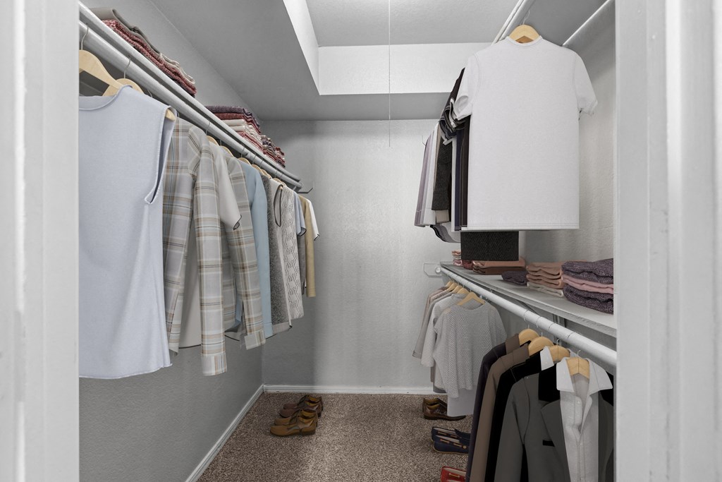 a walk in closet filled with clothes and shoes