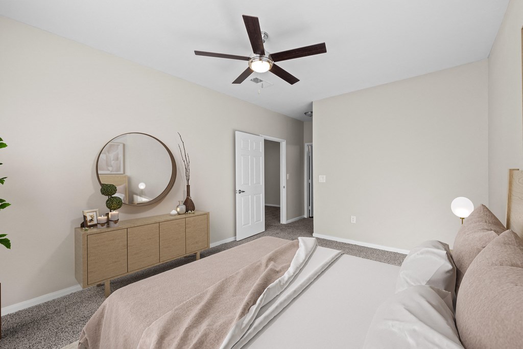 a bedroom with a large bed and a ceiling fan