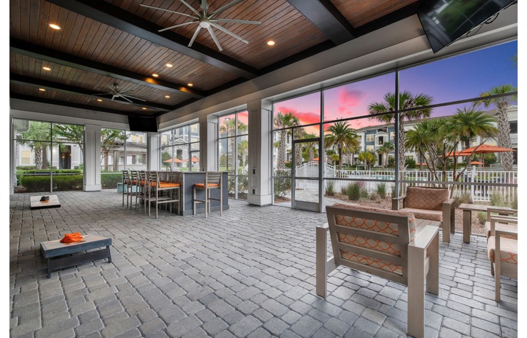 a patio with a dining area and a pool