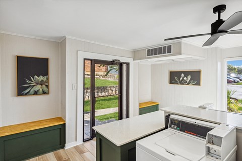 a kitchen with a stove and a door to a patio
