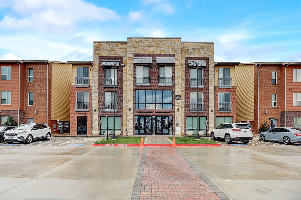 a brick building with cars parked in front of it