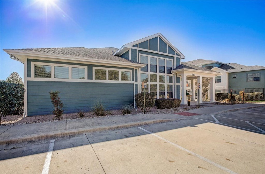 the front of a house with a driveway and a car garage