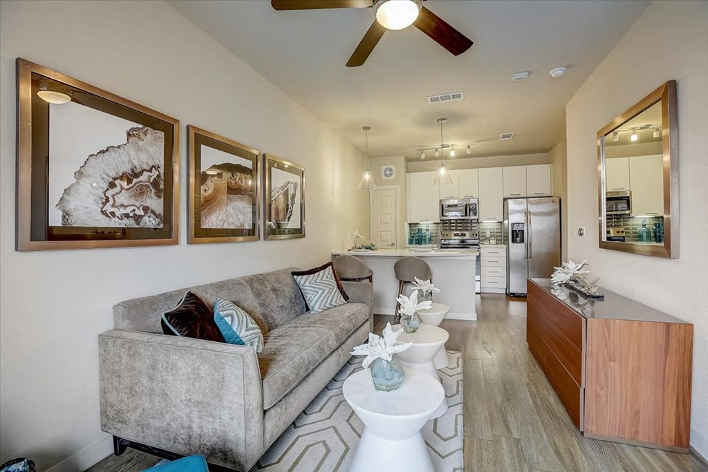 a living room with a couch and a kitchen