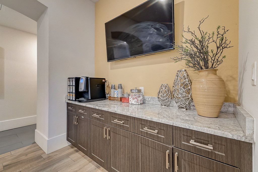 a kitchen with a counter with a vase and a coffee maker on it