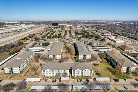 an aerial view of a city with houses and a highway