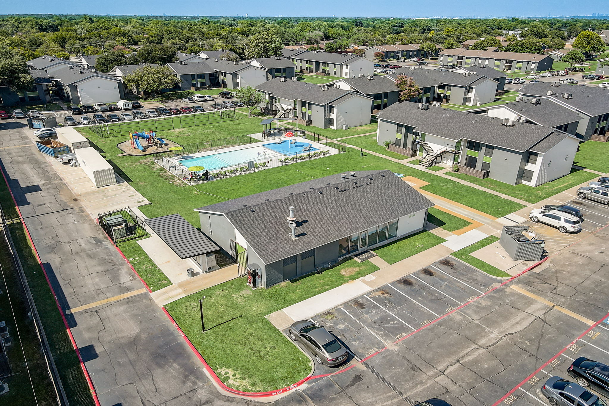 arial view of a neighborhood with houses and a pool