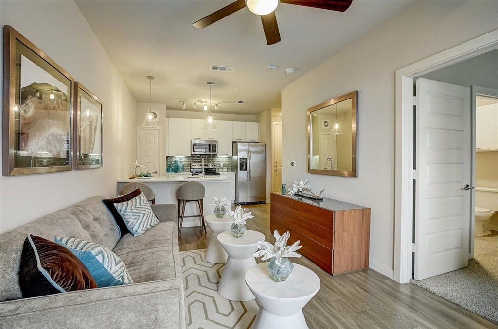 a living room and kitchen with a couch and a table