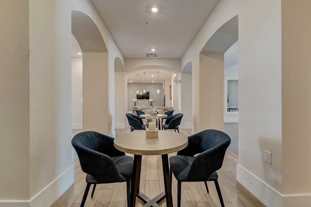 a dining room with blue chairs and a wooden table