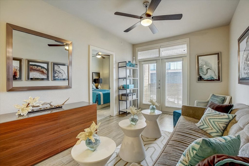 a living room with a couch and a ceiling fan