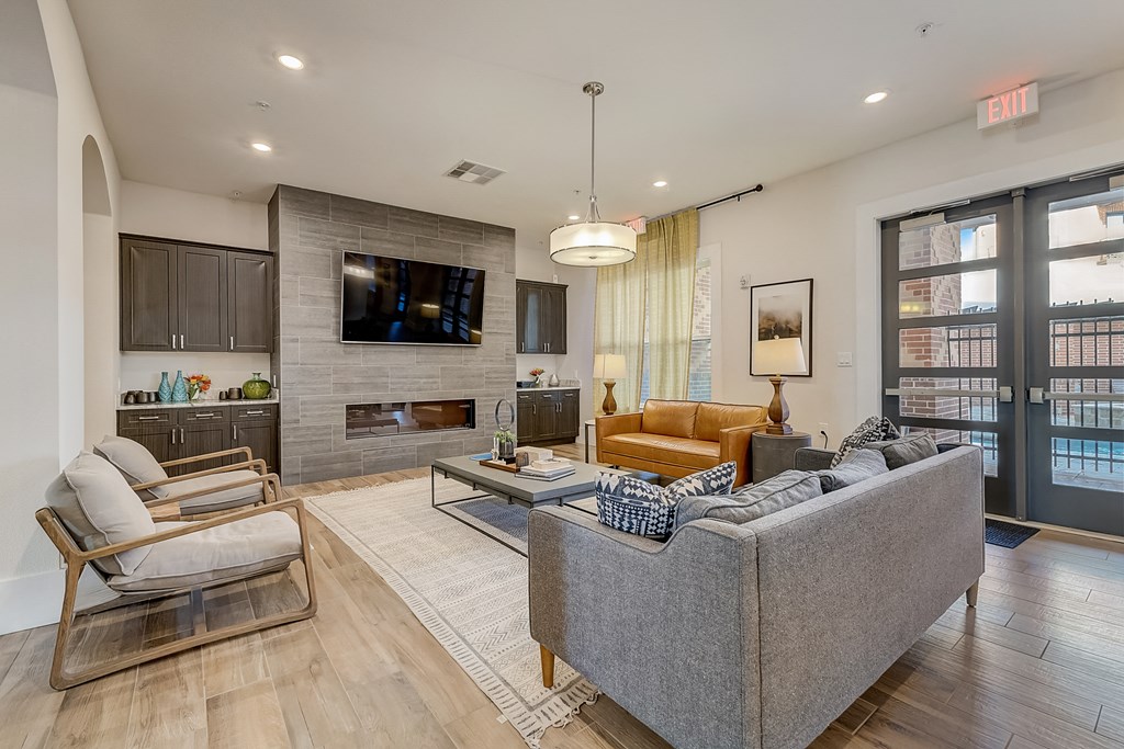 a living room with a couch and a chair and a television