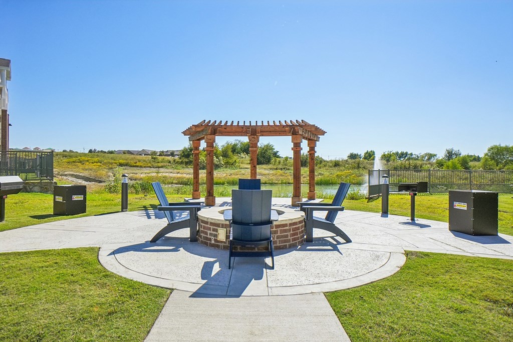 A gazebo sits in the middle of a circular walkway with benches on either side.