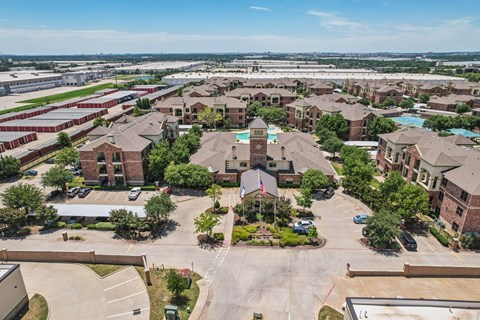 A large, open courtyard surrounded by brick buildings.