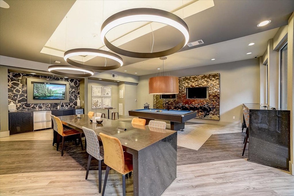 a large kitchen with a long table and a pool table