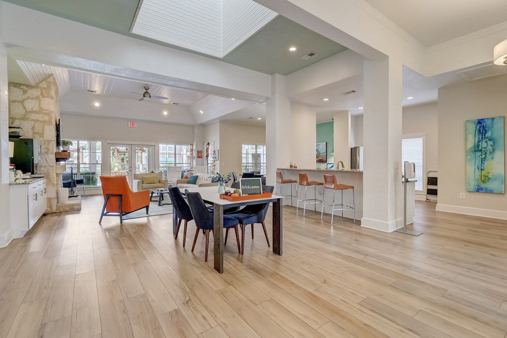 a dining room with a table and chairs in the center