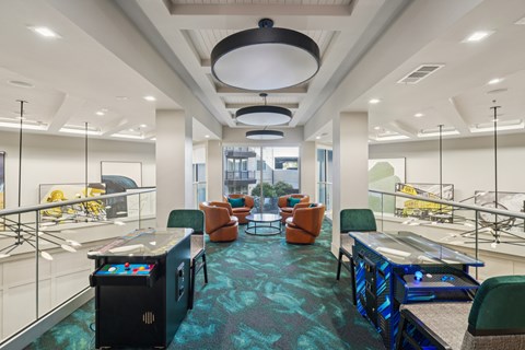A modern office space with a blue carpet and various seating arrangements.