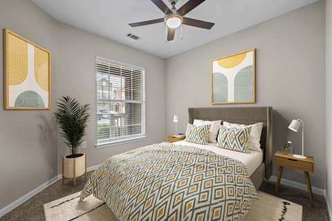 a bedroom with a large bed and a ceiling fan
