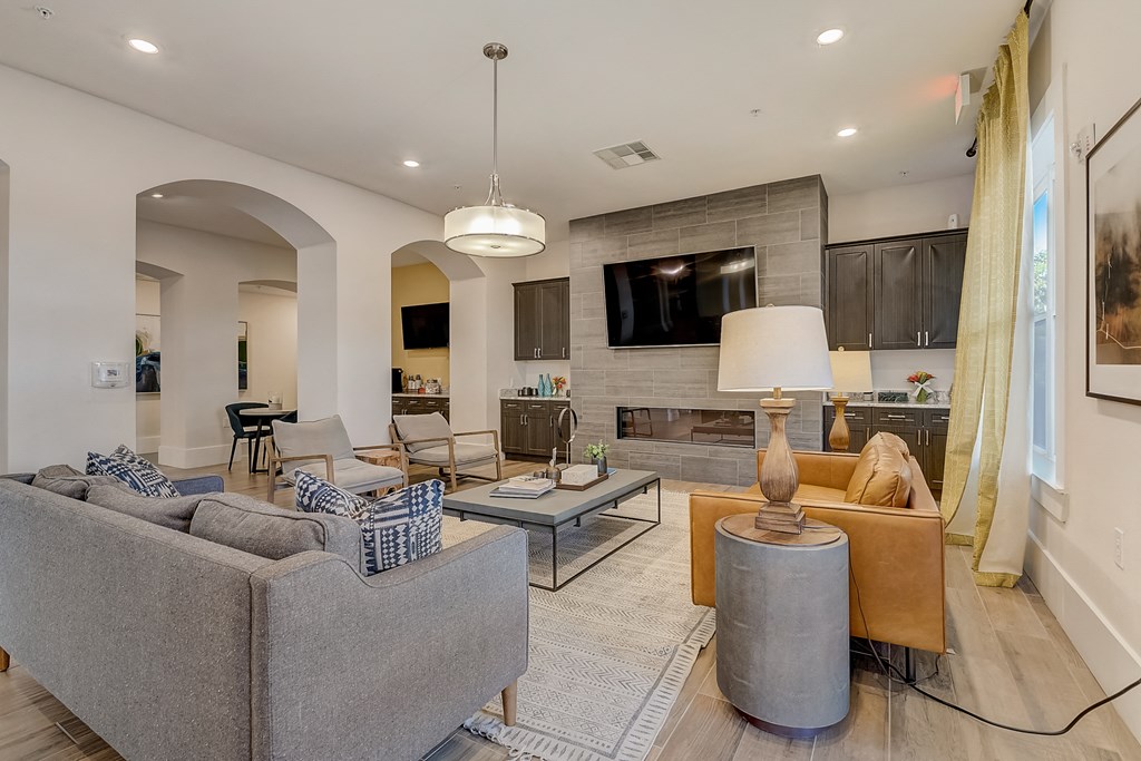 a living room with couches and chairs and a tv