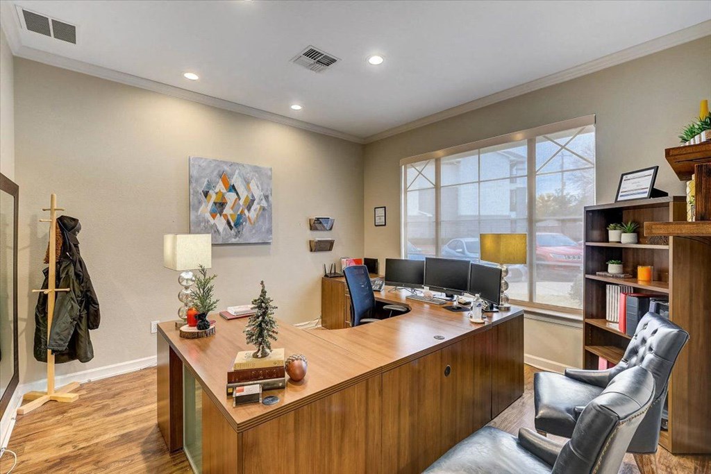 an office with a wooden desk and a window