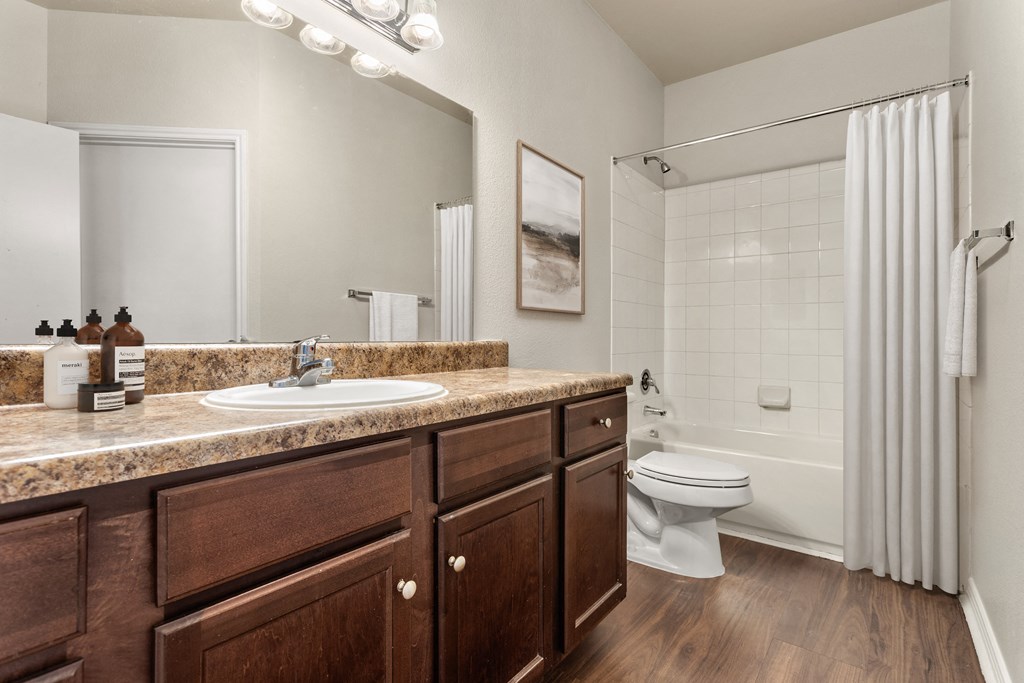a bathroom with a sink toilet and shower