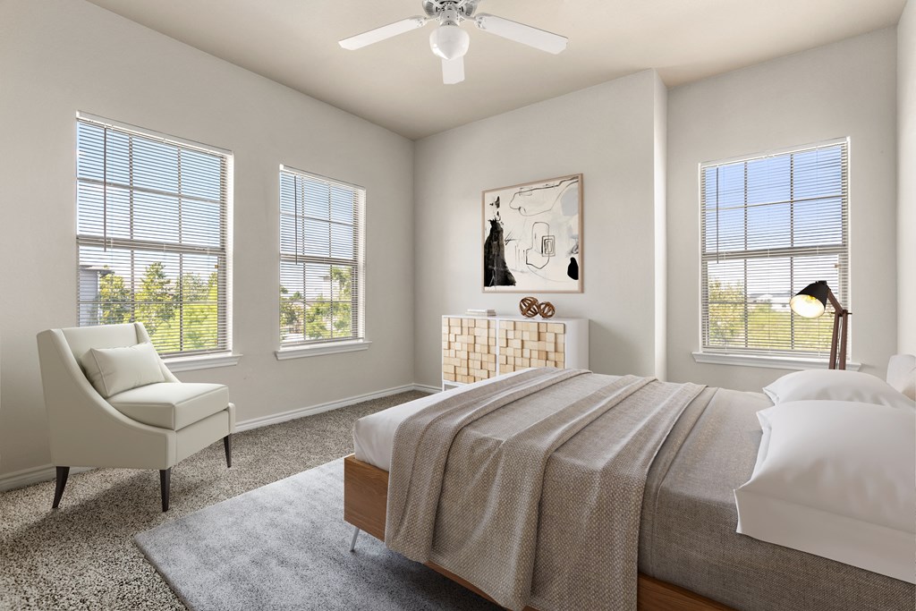 a bedroom with four windows and a ceiling fan