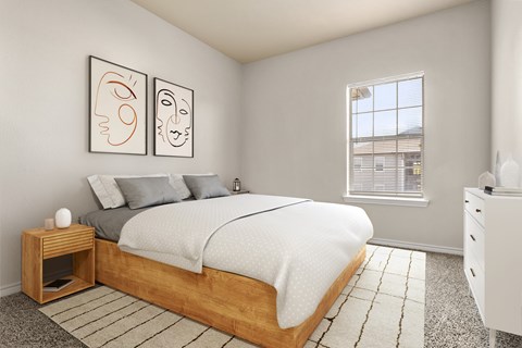 Primary bedroom with platform bed, modern wall art, and large window.
