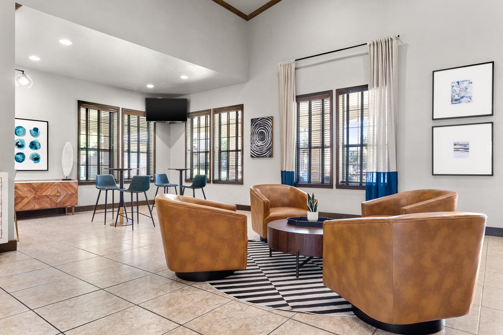 a resident clubhouse with couches chairs and a coffee table