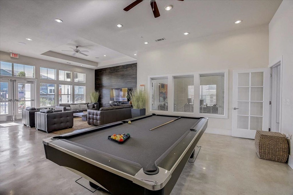 a pool table is in the center of a living room