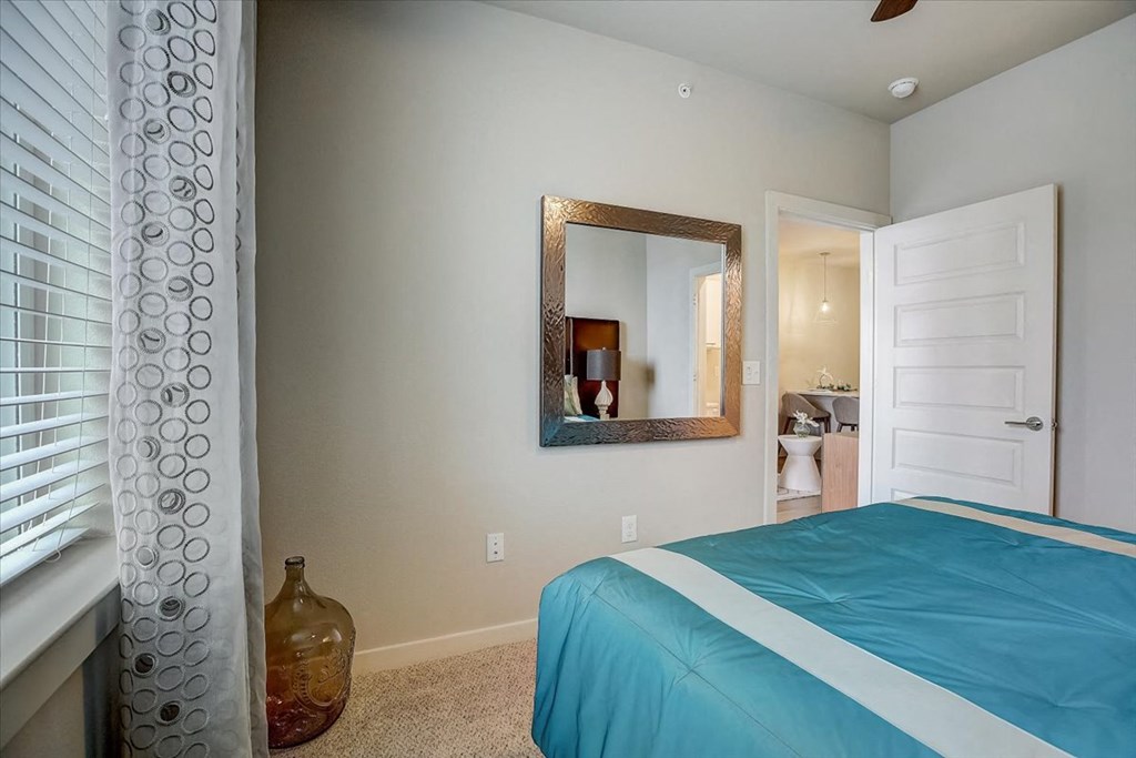 a bedroom with a bed and a door to a bathroom