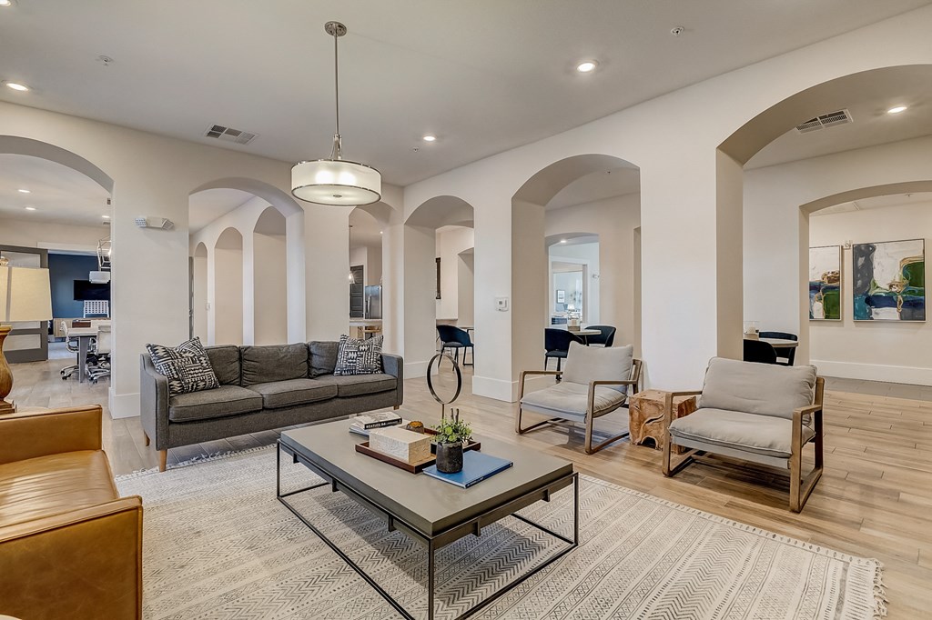 a living room with couches and chairs and a coffee table