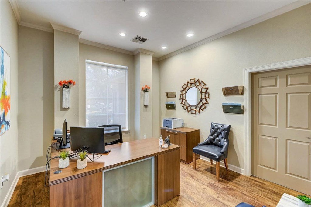 a home office with a desk and a window