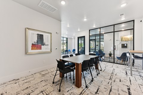 A conference room with a large table and chairs.