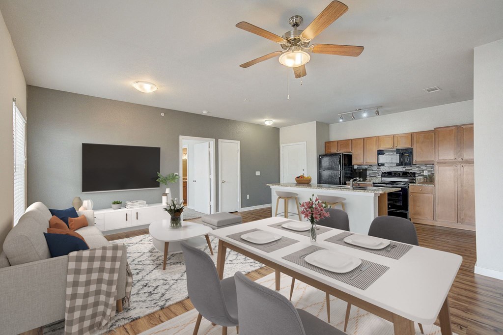 a living room with a dining room table and a kitchen