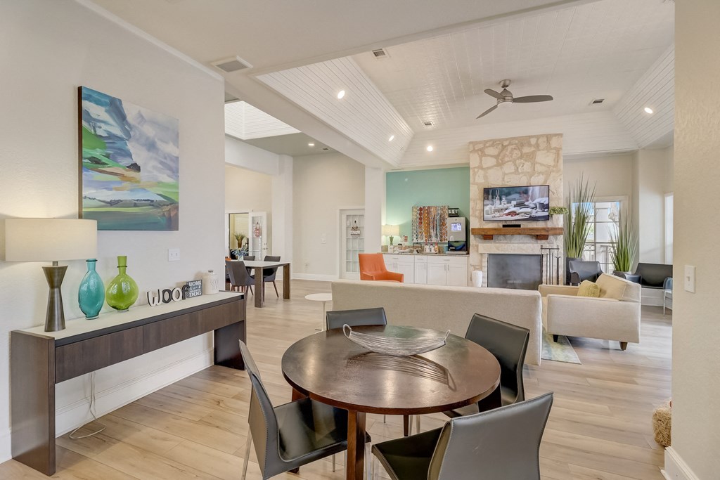 a living room and dining room with a table and chairs
