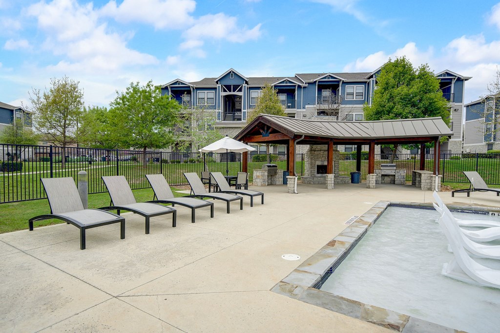 the preserve at ballantyne commons pool and patio with chairs and a pavilion