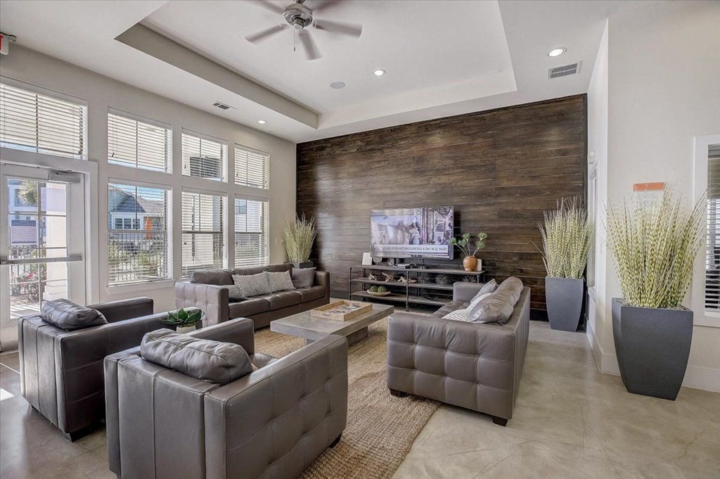 a living room with leather couches and a television