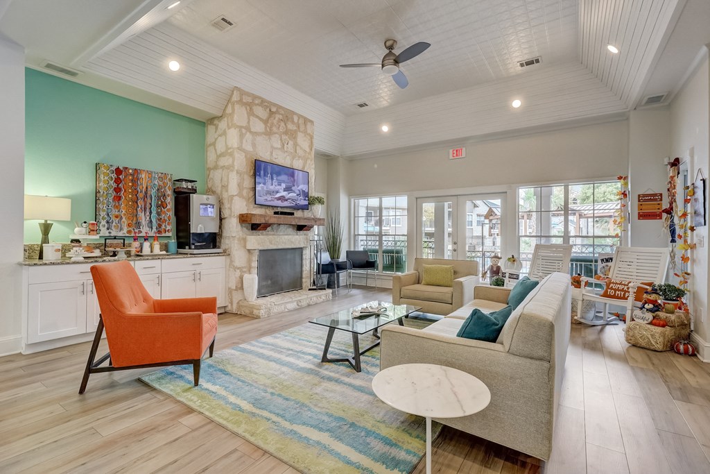 a living room with couches and chairs and a fireplace