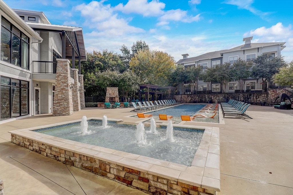 the preserve at ballantyne commons pool with water feature and lounge chairs