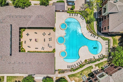 A large outdoor swimming pool with a slide.